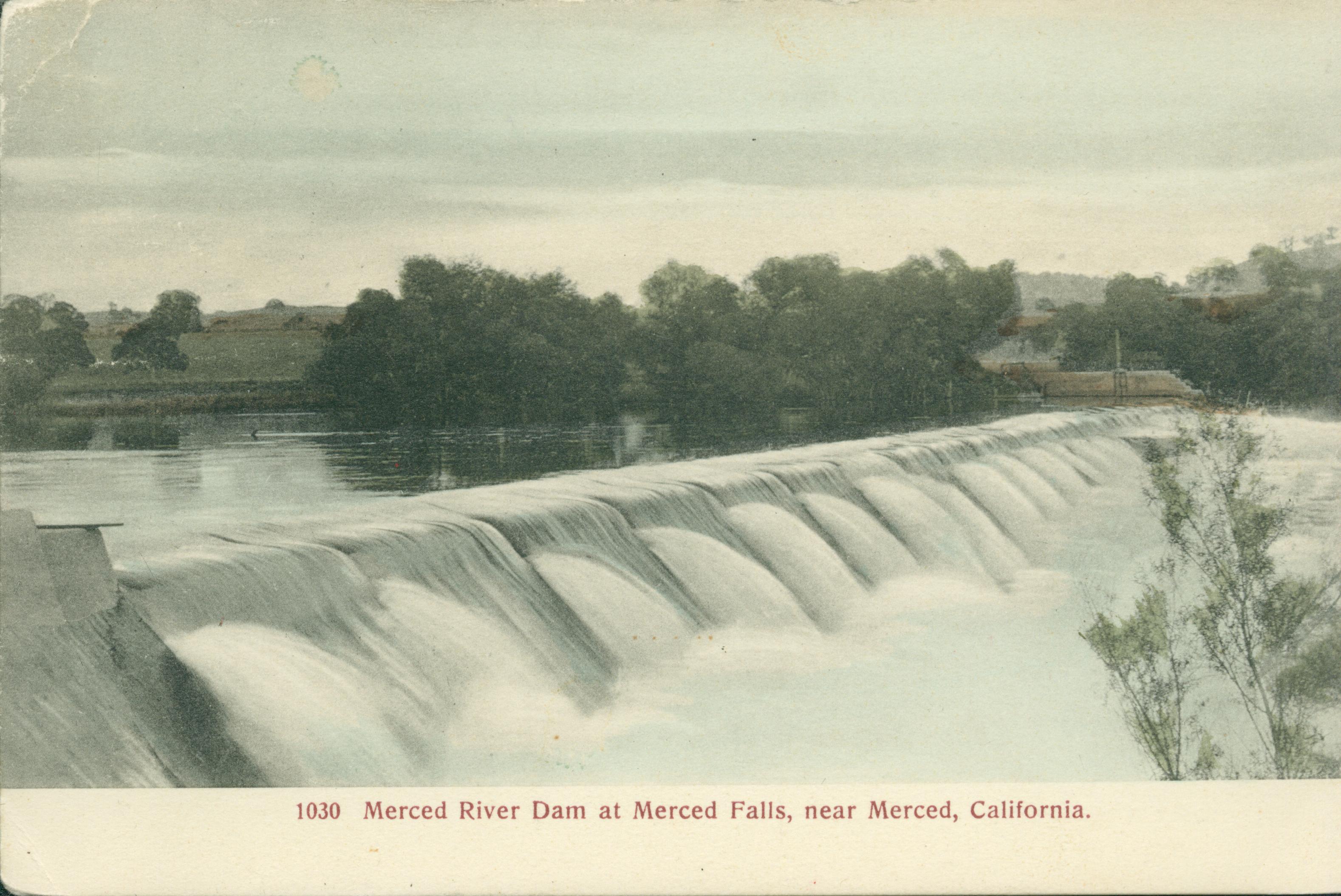 This postcard shows water spilling over a dam.